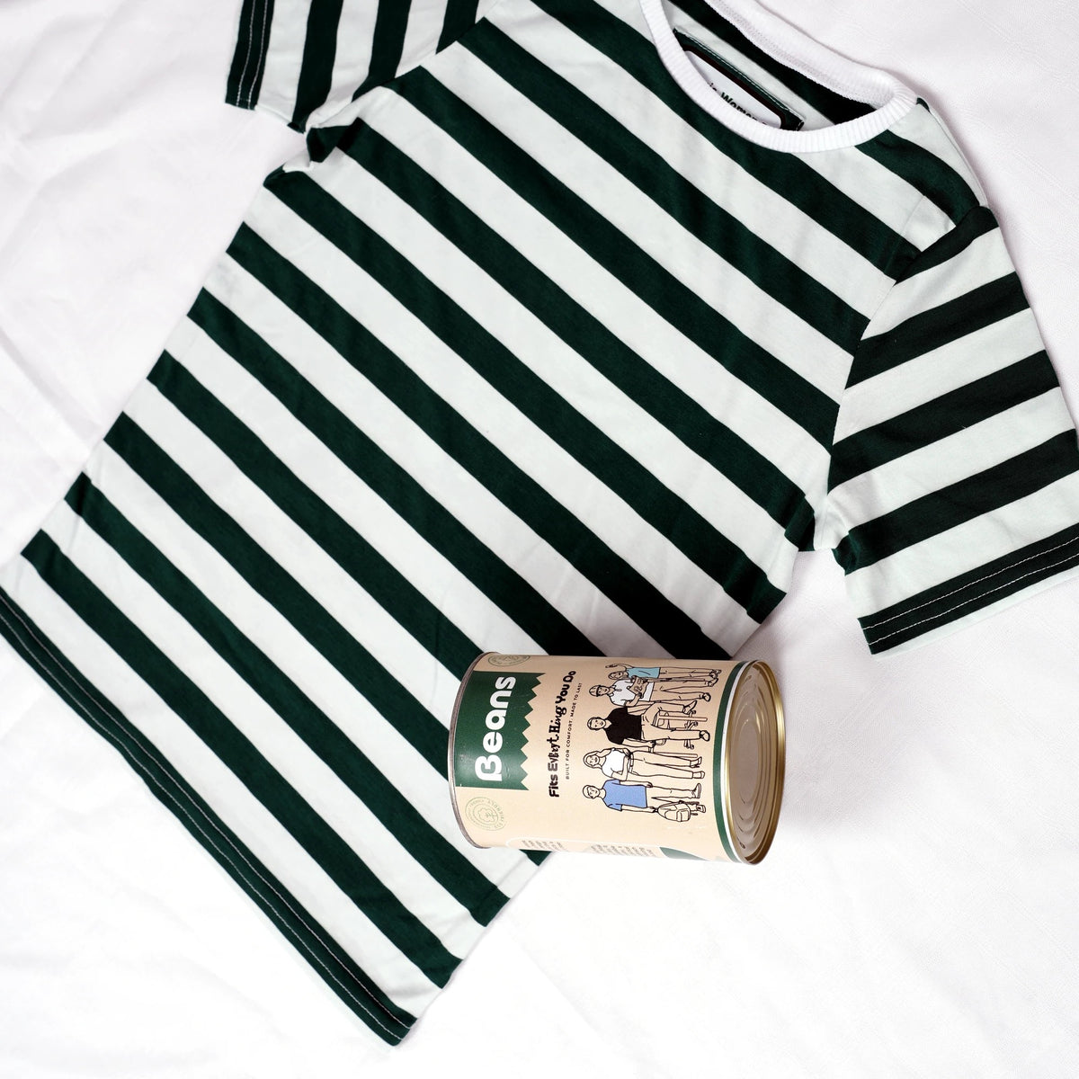 Beans green and white striped women's t-shirt next to reusable metal packaging can
