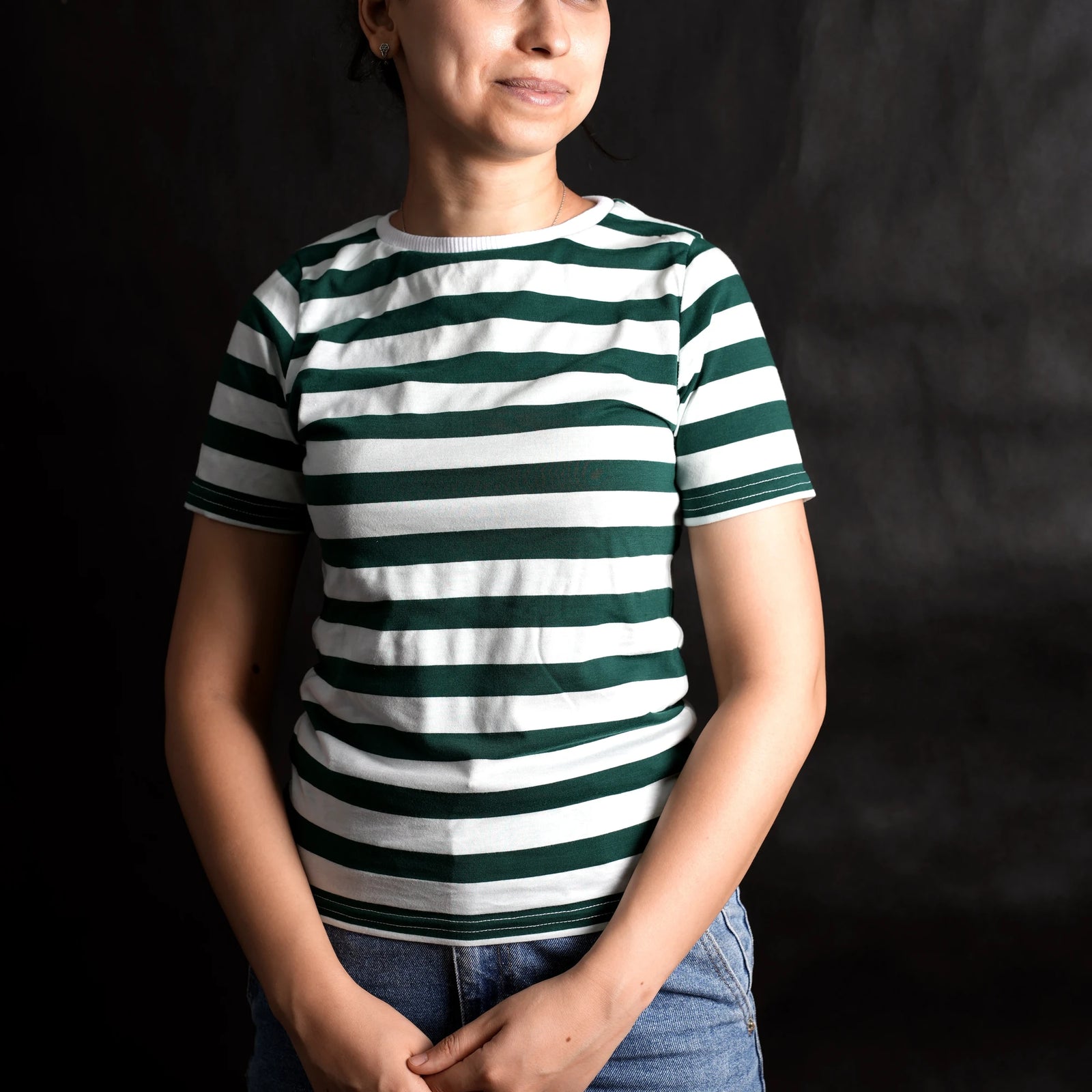 Woman wearing a classic green and white striped streetwear t-shirt by Beans.