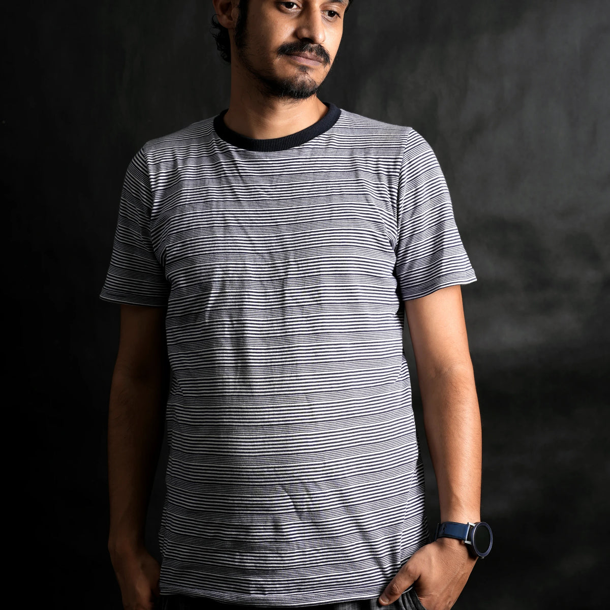 Man wearing The Men's Classic Stripe minimalist streetwear t-shirt by Beans.