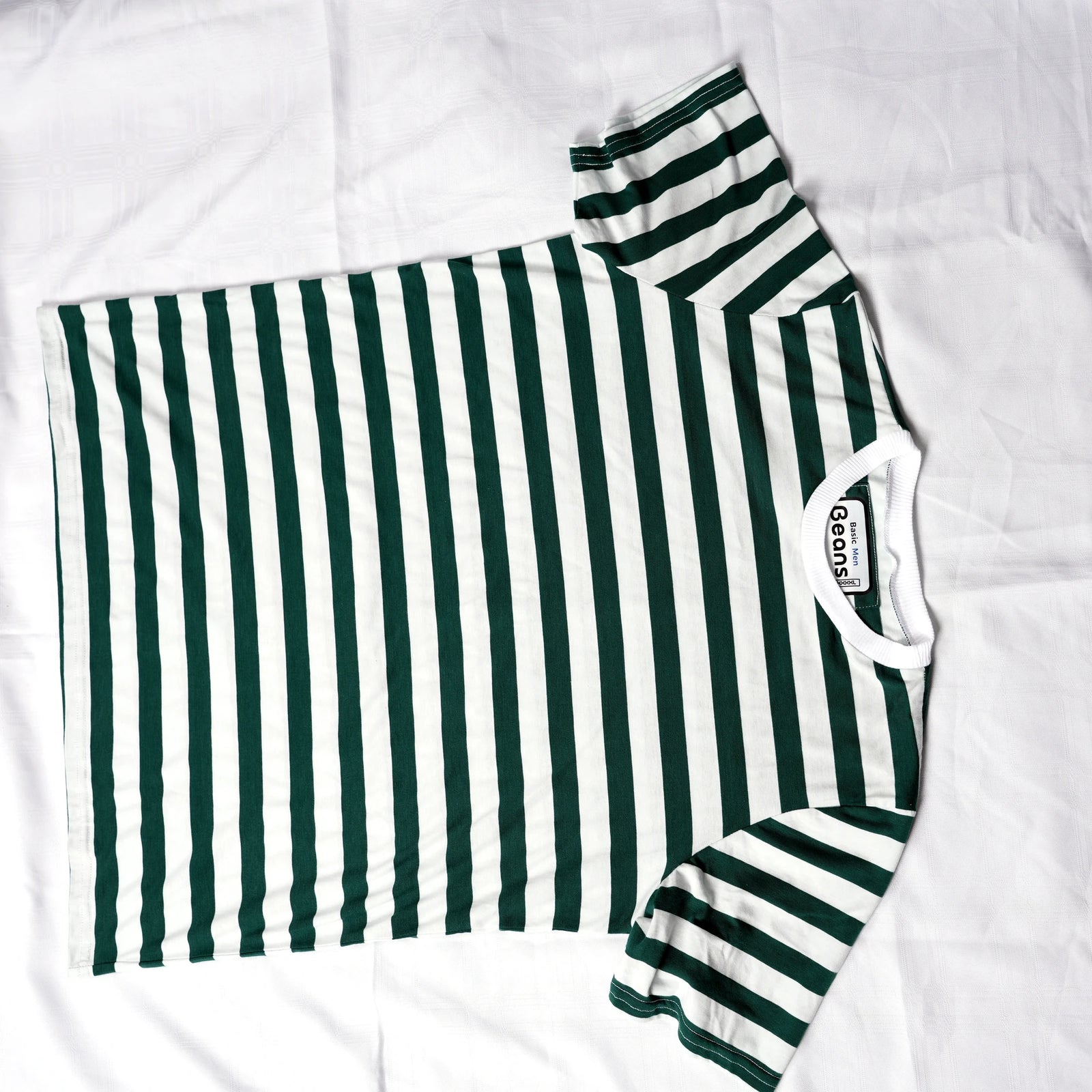 Beans green and white striped men's t-shirt laid flat on white backdrop.