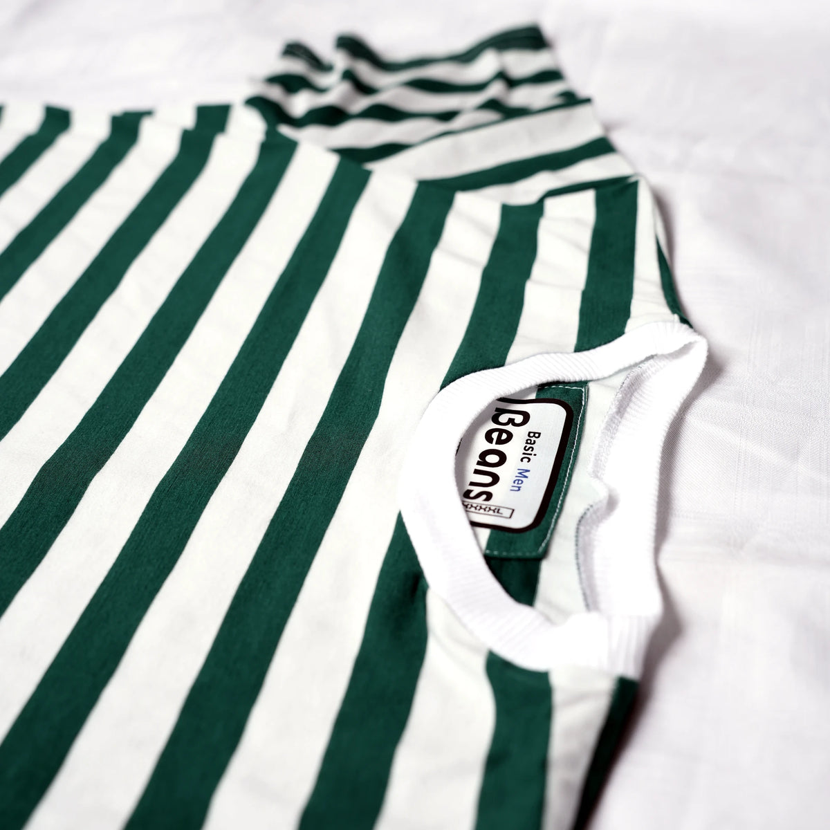 Beans green and white striped men's t-shirt laid flat on white backdrop.