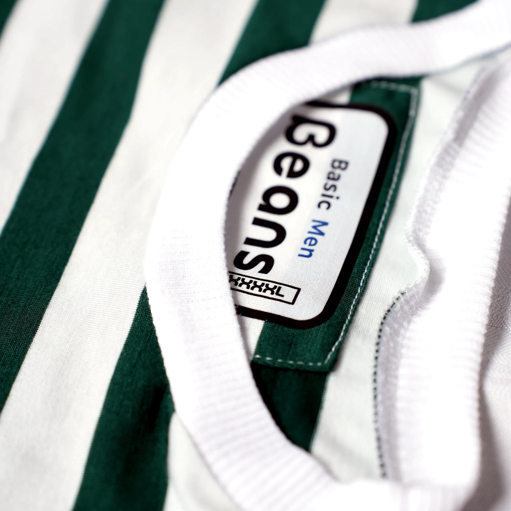 Close-up of the ribbed collar and Beans Basic Men brand tag on a green striped t-shirt.
