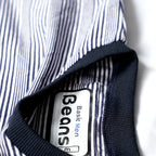 Close-up of the Beans Basic Men label and dark ribbed collar on a fine-striped t-shirt.